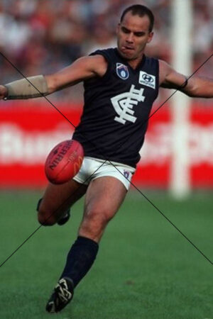 Greg Williams mid-kick in vintage Carlton gear