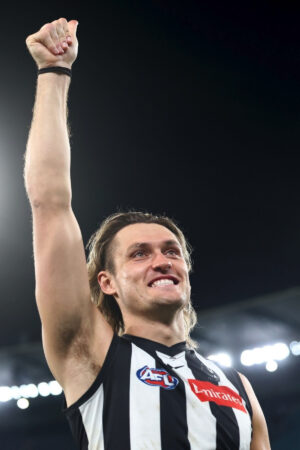 Darcy Moore Raising Fist Under Stadium Lights 6" x 4" Photo Print