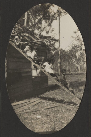 Children Sitting On Ladder Against Roof 6" x 4" Photo Print