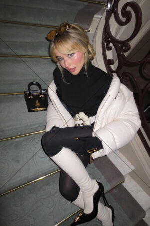 Sabrina Carpenter seated on stairs in white jacket and black outfit 6"x 4" Photo Print