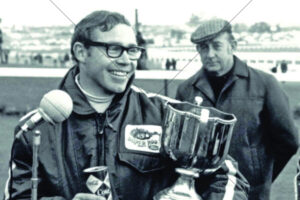 Allan Moffat celebrating with trophy and Coke 6" x 4" Photo Print