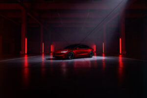 Tesla Model 3 Performance red in red lit studio 6" x 4" Photo Print