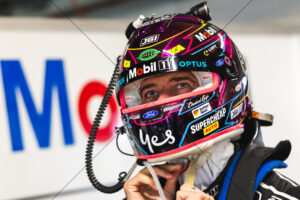 Chaz Mostert fastening colourful race helmet in garage 6" x 4" Photo Print