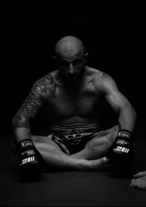 Alexander Volkanovski Seated Gloves B-W A4 Poster Print